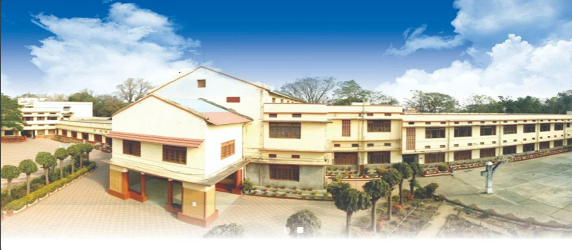The school building and its courtyard, seen from above the garden